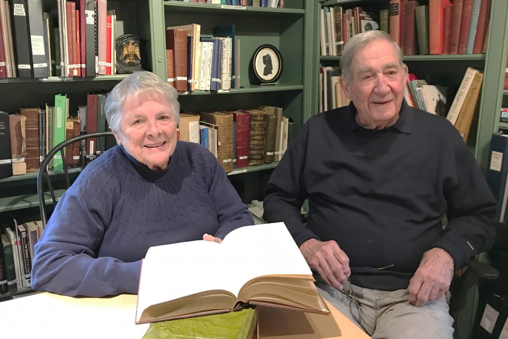 two people sitting at a table in the Scott House library